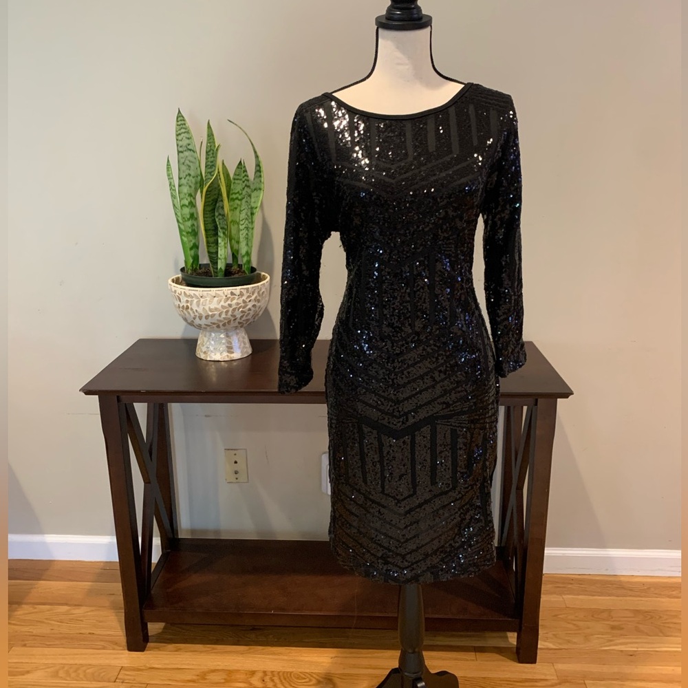 Black sequins dress. Zipper in the back of dress.